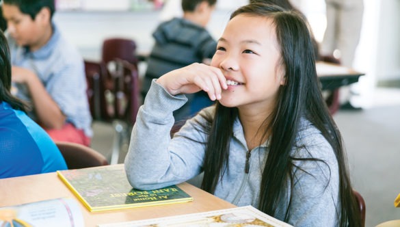 a student is smiling during a reading group