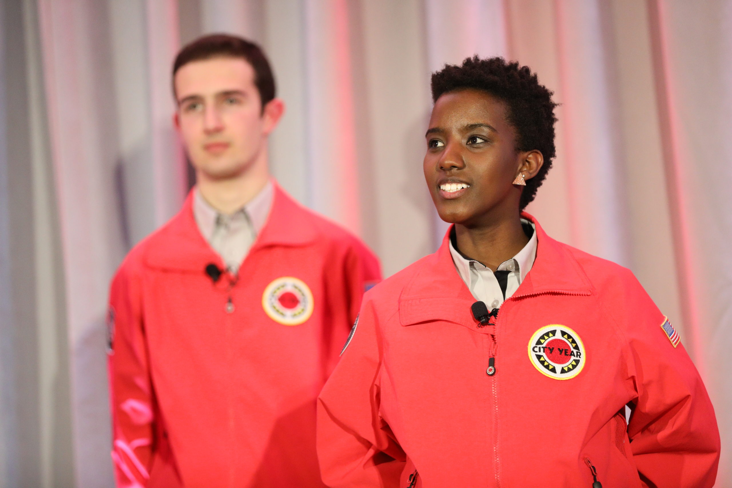 AmeriCorps members proudly present their service to the audience.