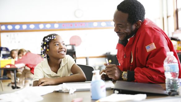 City Year AmeriCorps member with students in school