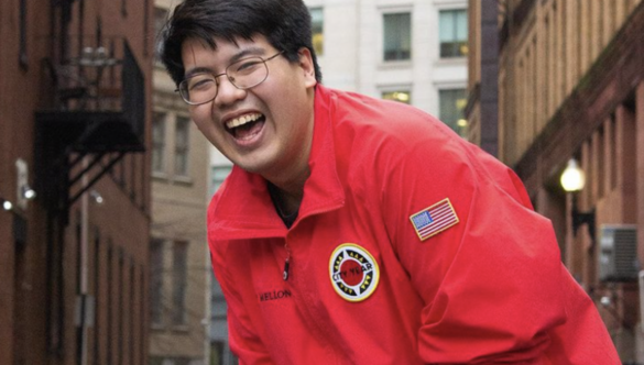 Henry Le smiling in City Year Red Jacket