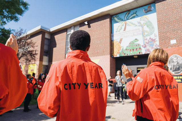City Year Philadelphia AmeriCorps members greet students outside the school